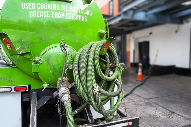 pumping out a heavy-duty grease trap at a restaurant in Belmont